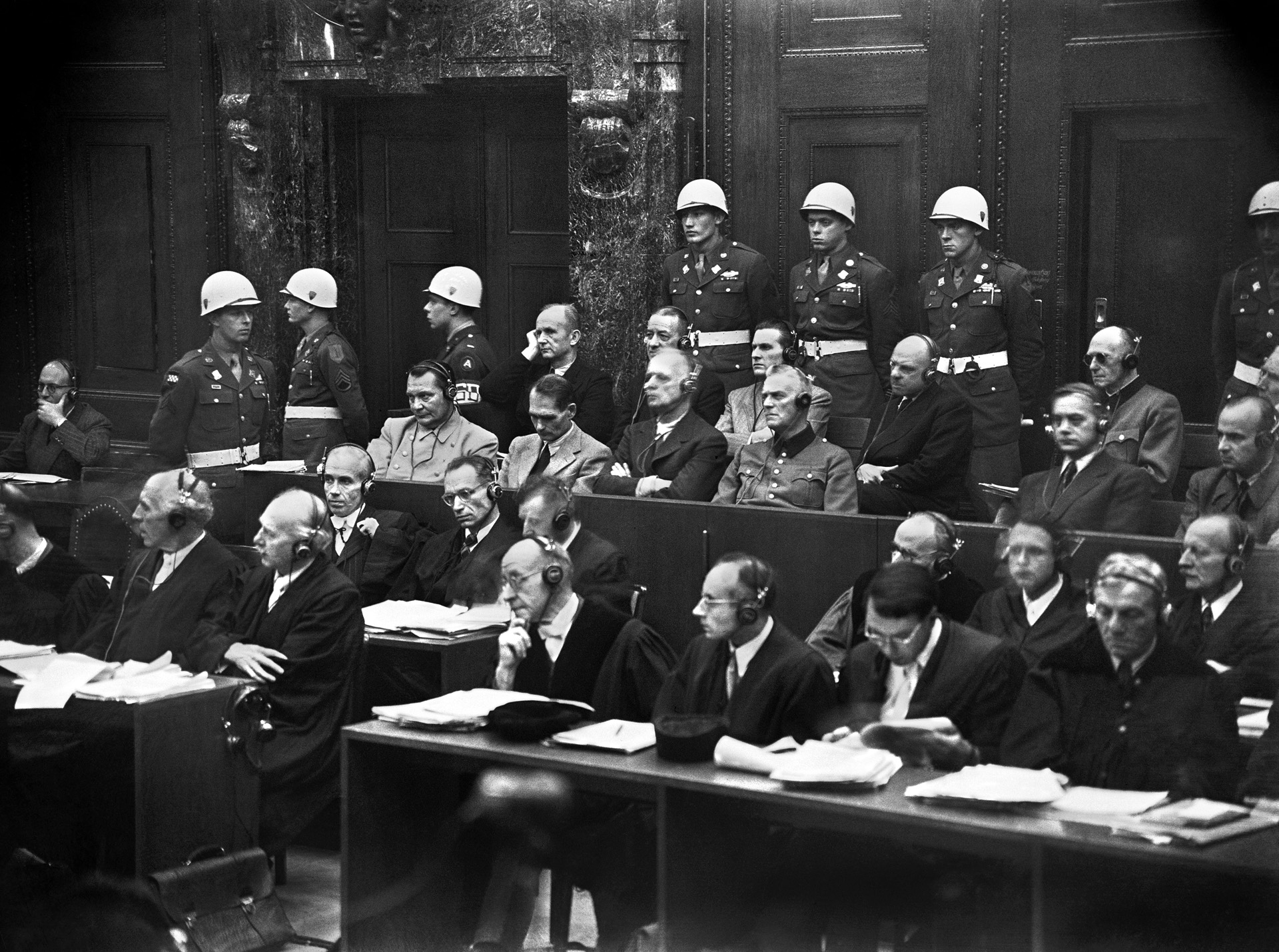 Twenty-two members of the Nazi regime on trial at Nuremberg for their part in war crimes. This, the first of 13 tribunals, lasted 11 months—from November 1945 until October 1946. Ten men were hanged; three committed suicide in prison.